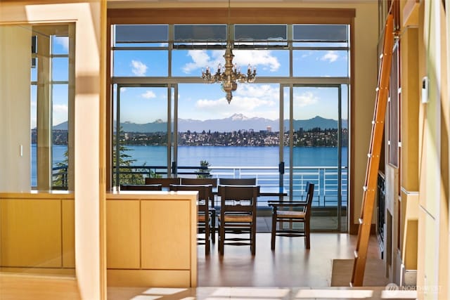 5511 104th Ave NE, Kirkland, WA 98033 - dining space featuring a chandelier, healthy amount of natural light, and a water and mountain view