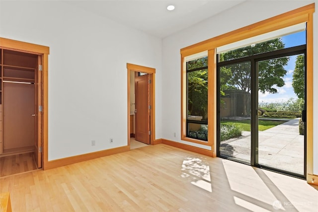 5511 104th Ave NE, Kirkland, WA 98033 - unfurnished bedroom with wood finished floors, access to outside, ensuite bathroom, and a walk in closet