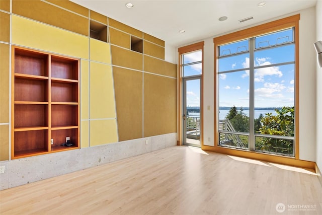 5511 104th Ave NE, Kirkland, WA 98033 - empty room featuring a water view and wood finished floors