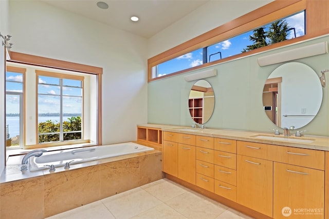 5511 104th Ave NE, Kirkland, WA 98033 - bathroom featuring double vanity, tile patterned flooring, a garden tub, and a water view