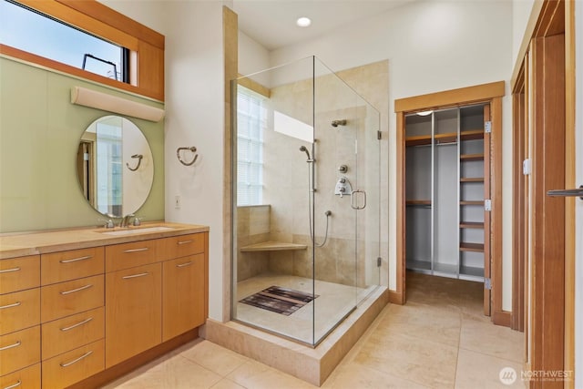 5511 104th Ave NE, Kirkland, WA 98033 - full bath featuring vanity, a shower stall, tile patterned flooring, and a walk in closet