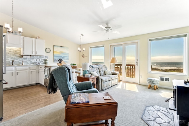 1311 Ocean Shores Blvd SW Unit 5, Ocean Shores, WA 98569 - living area featuring a chandelier, ceiling fan, and light carpet