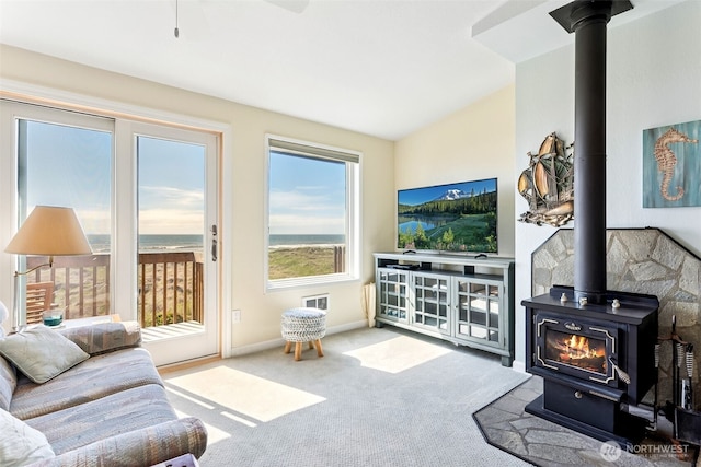 1311 Ocean Shores Blvd SW Unit 5, Ocean Shores, WA 98569 - living area with a wood stove, carpet flooring, and lofted ceiling