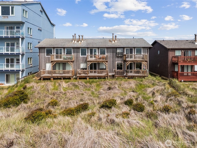 1311 Ocean Shores Blvd SW Unit 5, Ocean Shores, WA 98569 - back of house featuring a balcony and a shingled roof