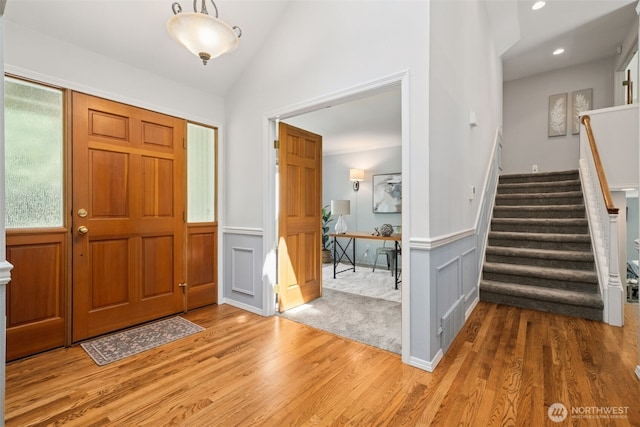 28314 180th Ave SE, Covington, WA 98042 - foyer entrance featuring wood finished floors, stairway, wainscoting, lofted ceiling, and recessed lighting