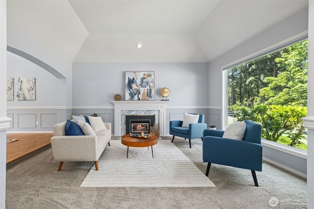28314 180th Ave SE, Covington, WA 98042 - carpeted living area featuring a fireplace, lofted ceiling, and wainscoting