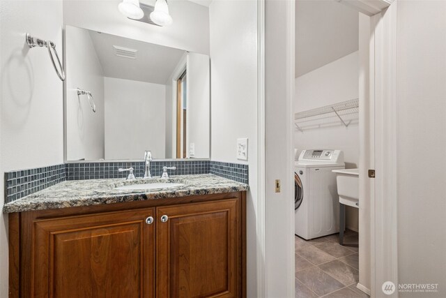 28314 180th Ave SE, Covington, WA 98042 - bathroom featuring washer / clothes dryer, vanity, and tile patterned floors