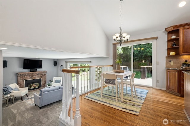 28314 180th Ave SE, Covington, WA 98042 - dining area featuring a fireplace, light wood-style floors, plenty of natural light, and high vaulted ceiling