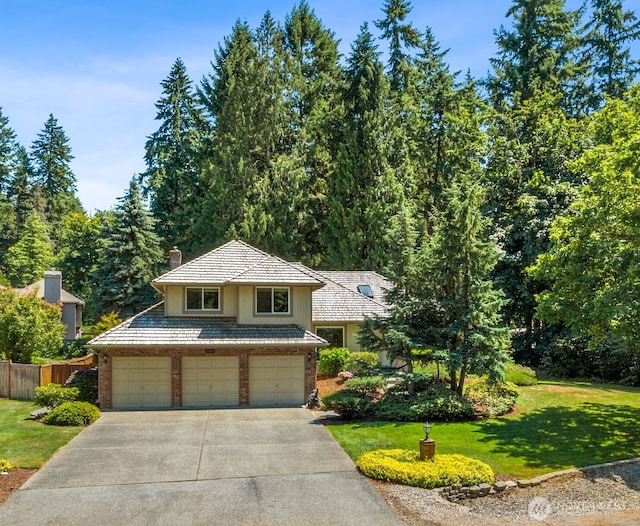 28314 180th Ave SE, Covington, WA 98042 - traditional-style home with driveway, a chimney, and an attached garage