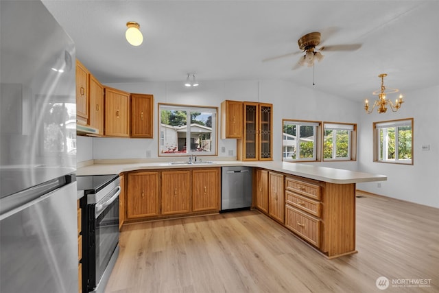 32820 20th Ave S Unit 35, Federal Way, WA 98003 - kitchen with appliances with stainless steel finishes, a peninsula, lofted ceiling, light wood-type flooring, and light countertops