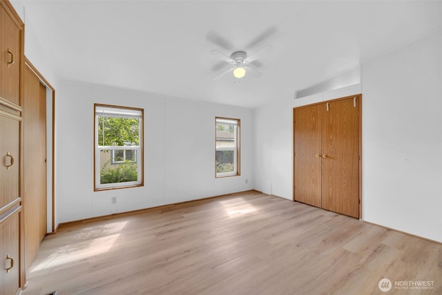 32820 20th Ave S Unit 35, Federal Way, WA 98003 - unfurnished bedroom with multiple windows, light wood finished floors, and ceiling fan