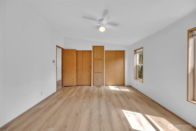 32820 20th Ave S Unit 35, Federal Way, WA 98003 - unfurnished bedroom with lofted ceiling, light wood-type flooring, ceiling fan, and multiple closets