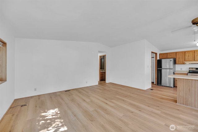 32820 20th Ave S Unit 35, Federal Way, WA 98003 - unfurnished living room featuring light wood-style flooring and vaulted ceiling