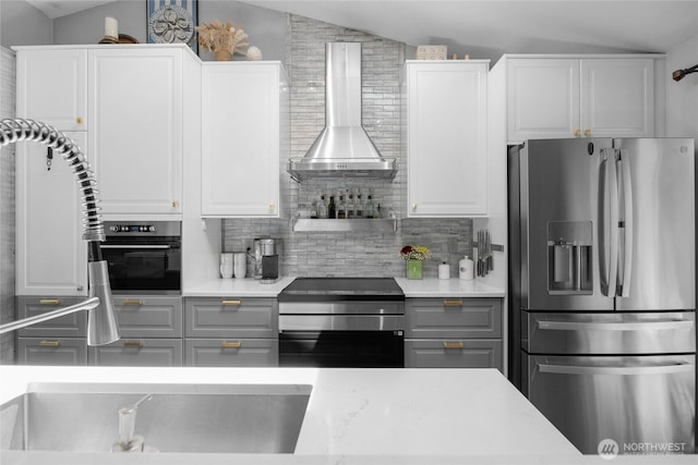 4418 85th Pl SW, Mukilteo, WA 98275 - kitchen featuring stainless steel appliances, wall chimney exhaust hood, lofted ceiling, backsplash, and light countertops
