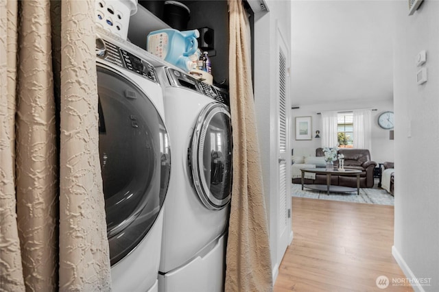 4418 85th Pl SW, Mukilteo, WA 98275 - laundry area featuring light wood finished floors and independent washer and dryer