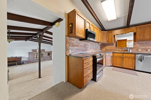 714 Canterbury Rd NW, Soap Lake, WA 98851 - kitchen with appliances with stainless steel finishes, light colored carpet, tasteful backsplash, brown cabinetry, and dark countertops