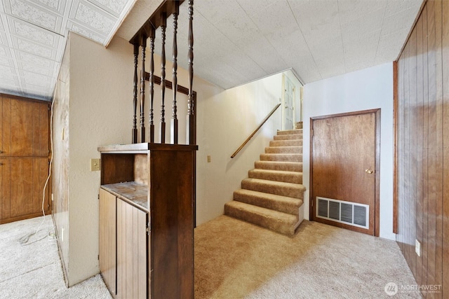 714 Canterbury Rd NW, Soap Lake, WA 98851 - staircase featuring carpet floors and wood walls