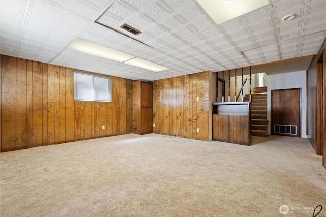 714 Canterbury Rd NW, Soap Lake, WA 98851 - unfurnished room with stairway, wood walls, and carpet floors