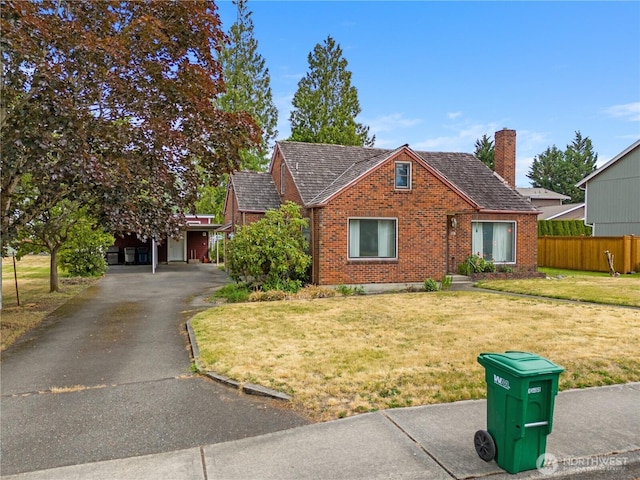 110 3rd Ave SW, Pacific, WA 98047 - view of front of house featuring brick siding, a chimney, and driveway