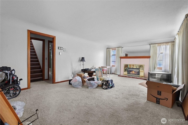 110 3rd Ave SW, Pacific, WA 98047 - carpeted living area featuring a glass covered fireplace and stairway