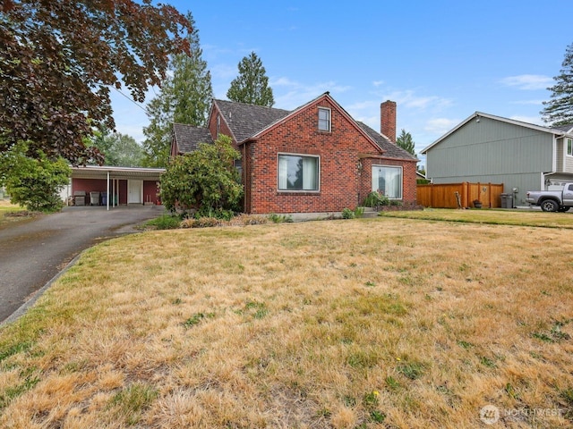 110 3rd Ave SW, Pacific, WA 98047 - view of front of property with a chimney, brick siding, driveway, and an attached carport