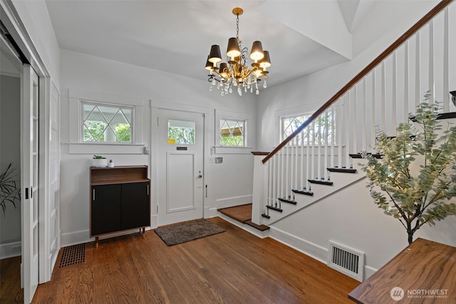 208 N Yakima, Tacoma, WA 98403 - foyer entrance with wood finished floors, a chandelier, and stairway