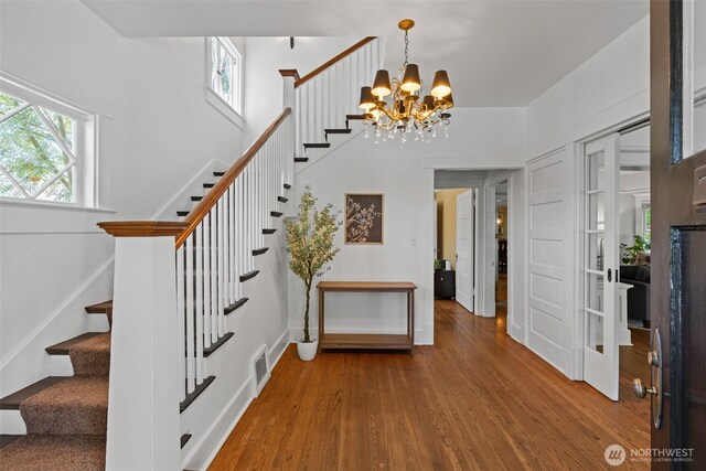 208 N Yakima, Tacoma, WA 98403 - stairway featuring wood finished floors and a chandelier