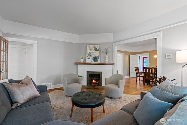 208 N Yakima, Tacoma, WA 98403 - living area featuring a brick fireplace and wood finished floors