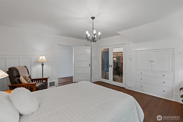 208 N Yakima, Tacoma, WA 98403 - bedroom with a chandelier, dark wood-style flooring, wainscoting, and french doors