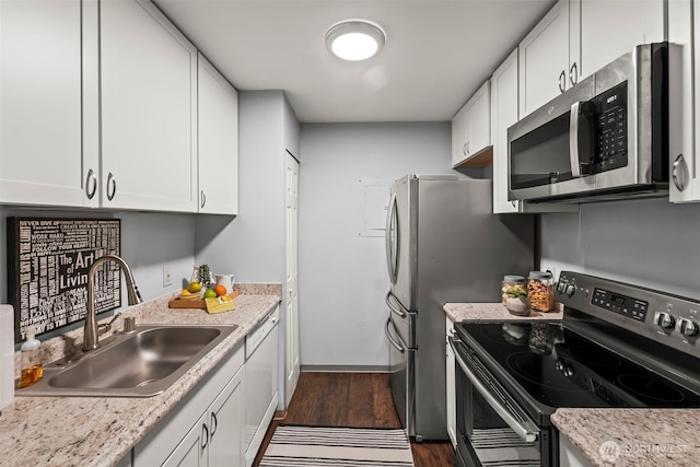 6105 N 16th St Unit N203, Tacoma, WA 98406 - kitchen featuring appliances with stainless steel finishes, white cabinetry, and dark wood-type flooring