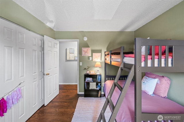 6105 N 16th St Unit N203, Tacoma, WA 98406 - bedroom with wood finished floors, a textured ceiling, and a closet