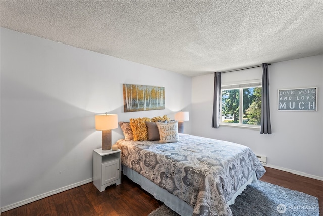 6105 N 16th St Unit N203, Tacoma, WA 98406 - bedroom featuring dark wood-style flooring, a textured ceiling, and a baseboard radiator
