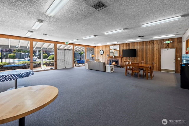 6105 N 16th St Unit N203, Tacoma, WA 98406 - carpeted living area with wood walls and a textured ceiling