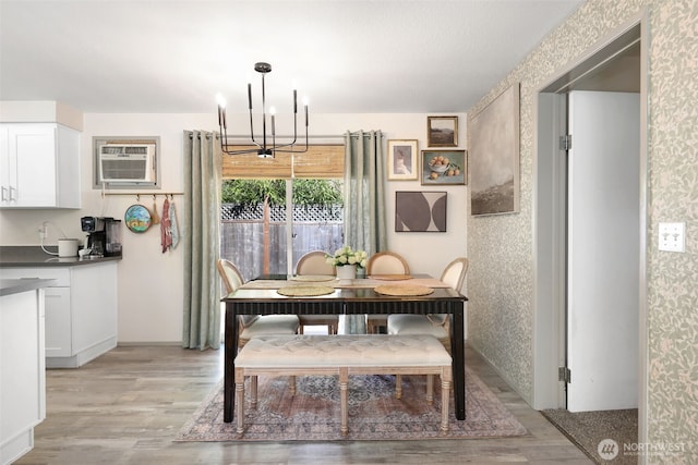 145 7th St, Gold Bar, WA 98251 - dining space featuring a wall mounted AC, a chandelier, light wood-style floors, and wallpapered walls