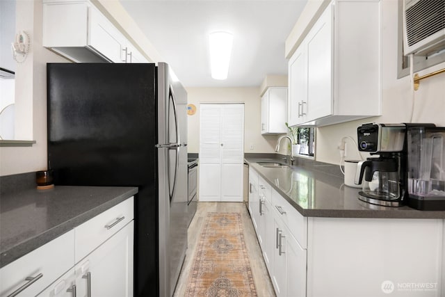 145 7th St, Gold Bar, WA 98251 - kitchen with freestanding refrigerator, white cabinetry, and range