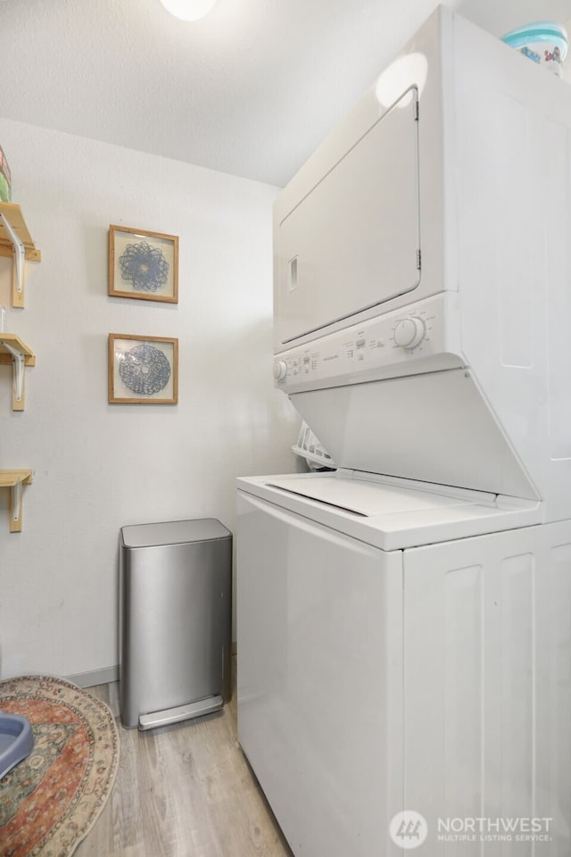 145 7th St, Gold Bar, WA 98251 - washroom featuring stacked washer / drying machine and light wood finished floors