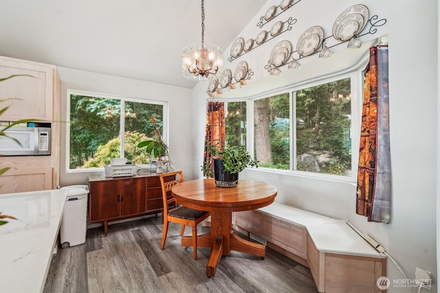 10125 Totem Way, Anderson Island, WA 98303 - dining area featuring wood finished floors, a chandelier, lofted ceiling, and a desk
