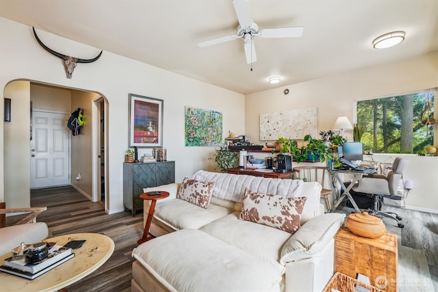 10125 Totem Way, Anderson Island, WA 98303 - living room featuring wood finished floors, arched walkways, a ceiling fan, and a desk