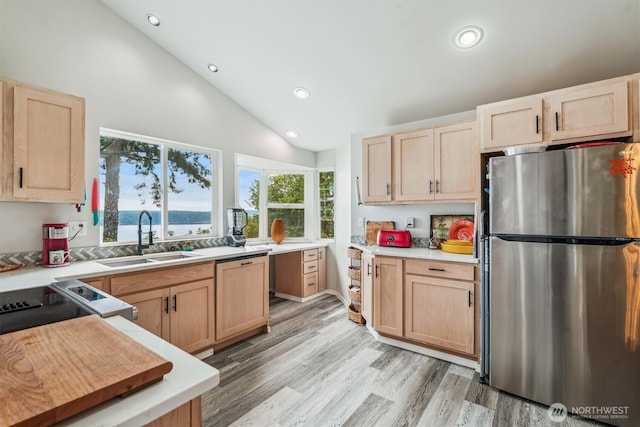 10125 Totem Way, Anderson Island, WA 98303 - kitchen with freestanding refrigerator, light brown cabinetry, paneled dishwasher, recessed lighting, and light countertops