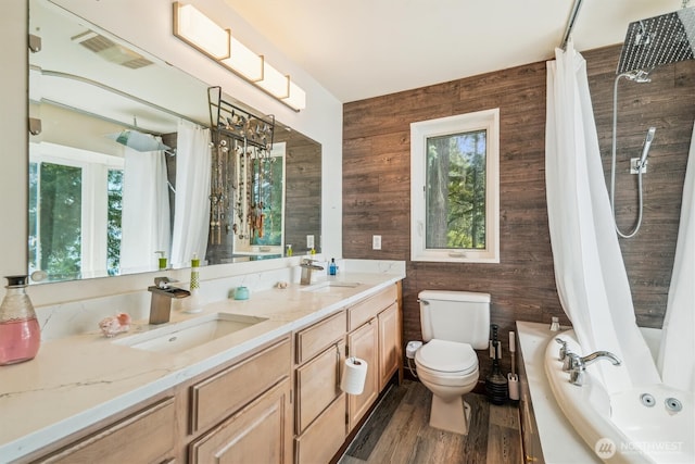 10125 Totem Way, Anderson Island, WA 98303 - bathroom with wooden walls, double vanity, a combined bath / shower with jetted tub, and wood finished floors