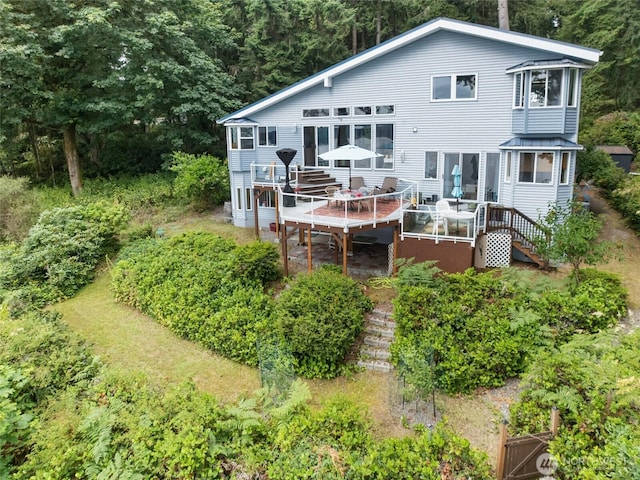 10125 Totem Way, Anderson Island, WA 98303 - rear view of house with a wooden deck and outdoor dining space