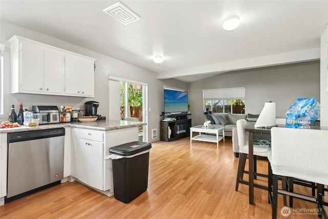 10421 19th Ave SE, Everett, WA 98208 - kitchen with stainless steel dishwasher, light wood-style floors, white cabinets, light countertops, and vaulted ceiling