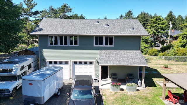 24523 L Ln, Ocean Park, WA 98640 - view of front of home with an attached garage, a shingled roof, and a patio