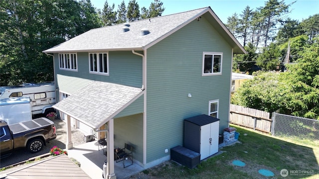 24523 L Ln, Ocean Park, WA 98640 - back of house featuring roof with shingles and a patio area
