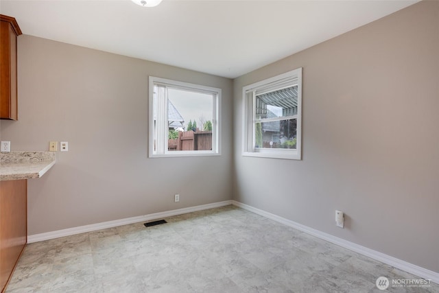 5030 S Park Ave S, Tacoma, WA 98408 - unfurnished dining area featuring baseboards