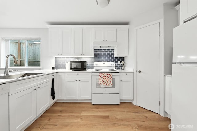 3806 Wetmore Ave, Everett, WA 98201 - kitchen with white appliances, premium range hood, tasteful backsplash, and light countertops