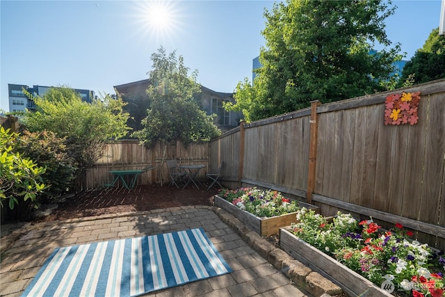 12723 35th Ave NE Unit B, Seattle, WA 98125 - fenced backyard featuring a patio area and a garden