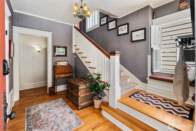 503 12th Ave E, Seattle, WA 98102 - stairway with wood finished floors, a chandelier, and ornamental molding