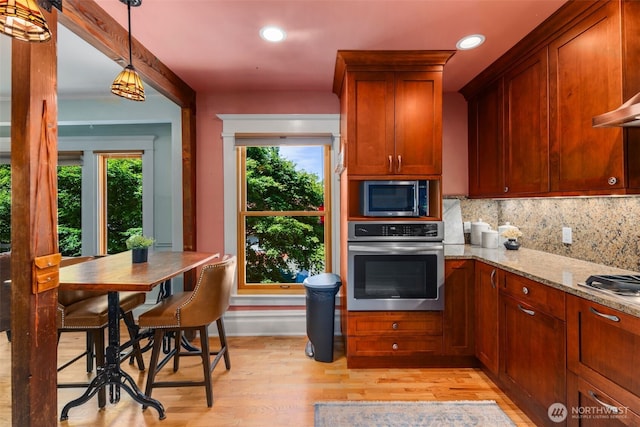503 12th Ave E, Seattle, WA 98102 - kitchen featuring stainless steel appliances, light wood-style floors, light stone counters, tasteful backsplash, and recessed lighting