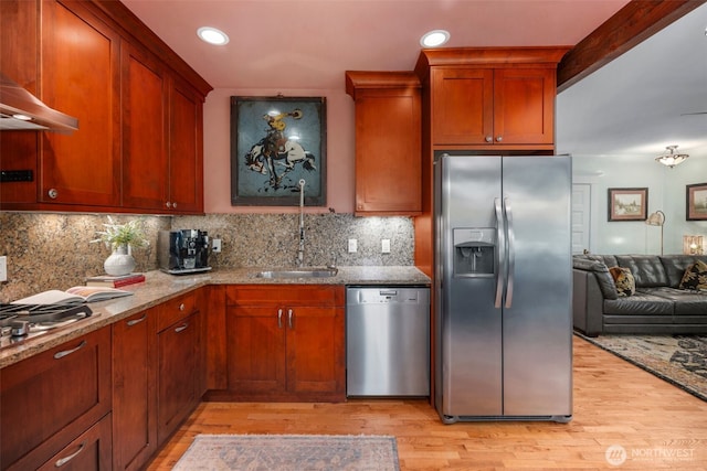 503 12th Ave E, Seattle, WA 98102 - kitchen with stainless steel appliances, wall chimney range hood, light wood-type flooring, light stone counters, and open floor plan